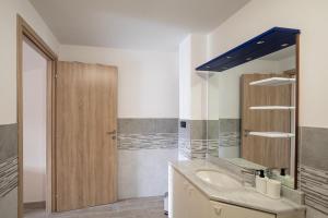 a bathroom with a sink and a mirror at Affittacamere Ca' Baldo in Finale Ligure