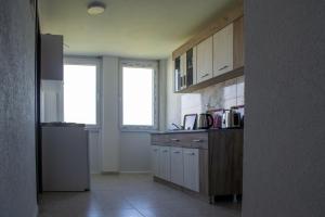 a kitchen with white cabinets and a counter top at Aida Apartments in Ulcinj