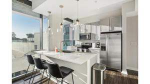 a kitchen with a counter and stools in it at Piedmont Park 1 bdrm in Atlanta