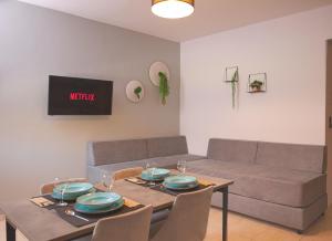 a living room with a table and a couch at Philippos & Alexandros Apartments in Tigaki