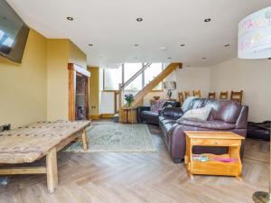 a living room with a couch and a table at The Barn in Holmfirth