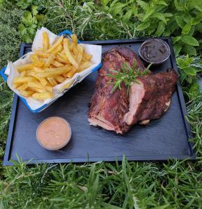 a plate of steak and french fries on a table at Hotel Dalla Posta Platta in Pardè