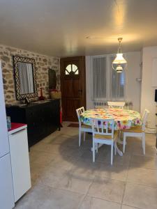 a kitchen and dining room with a table and chairs at La Canourguette in La Canourgue