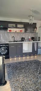 a kitchen with a sink and a stove at The Cwtch in Cardiff