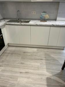 a kitchen with a sink and a counter top at LA CASA DEL MUELLE in Avilés +14 photos