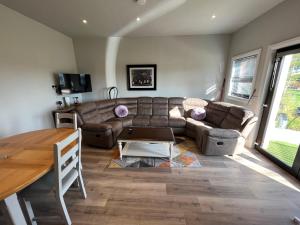 a living room with a couch and a table at Knockreagh Farm Cottages Mountain or Cedar views in Kilkenny