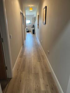 a hallway of a home with wooden floors at Knockreagh Farm Cottages Mountain or Cedar views in Kilkenny