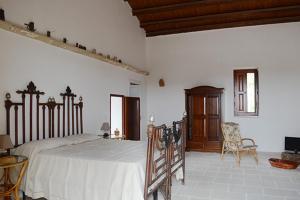 a bedroom with a large bed in a room at CASINO de VITI - Dimora storica con piscina in Vaste