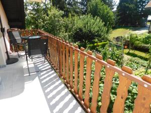 a wooden fence on a porch with a garden at Apartment Branko in Ptuj
