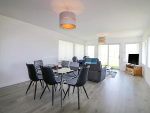 a living room with a table and chairs and a couch at 1 Westenra Gardens in Peterhead