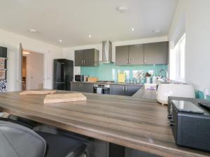 a kitchen with a large wooden table with chairs at 1 Westenra Gardens in Peterhead