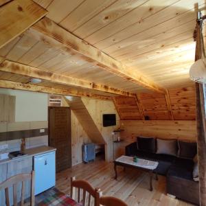 a living room with a couch and a table at Wooden cottage Podgora in Žabljak