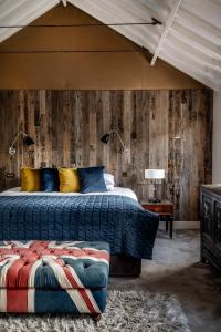 a bedroom with a bed and a wooden wall at York & Albany in London