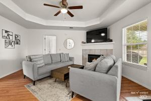 a living room with two couches and a fireplace at The Trailhead-1 2 mi to Applegate Trail in Bentonville