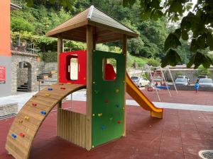 a playground with a slide in a park at Hotel Ristorante Grotto Serta in Lamone