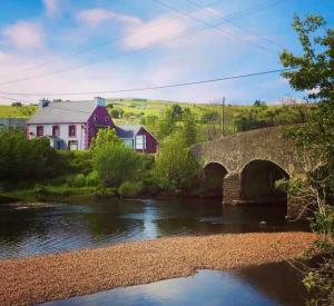 a house and a bridge over a river at Reelin bar holiday Accommodation in Cloghan