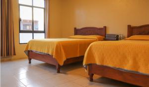 Letto o letti in una camera di Hotel Coroneo