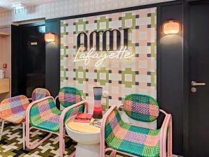 a restaurant with chairs and a table and a toilet at Aparthotel AMMI Nice Lafayette in Nice