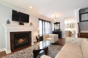 a living room with a fireplace and a tv at Luxury Home near Wrigley, Boystown & Andersonville in Chicago