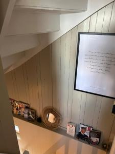 una pared con un estante con espejo y una pantalla en The View Guesthouse at Ekeberg -10 min by tram to Oslo S en Oslo