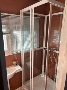 a glass shower in a bathroom with a sink at The View Guesthouse at Ekeberg -10 min by tram to Oslo S in Oslo