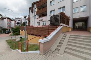 a building with a staircase in front of a building at Tjiraso Apartment in Gdańsk