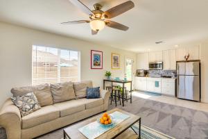 a living room with a couch and a kitchen at Newly Built Sparks Home with Hot Tub 12 Mi to Reno! in Sparks