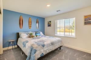 a bedroom with a bed and surfboards on the wall at Newly Built Sparks Home with Hot Tub 12 Mi to Reno! in Sparks