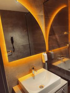 a bathroom with a sink and a mirror at Uzunkum Hotel in Trabzon
