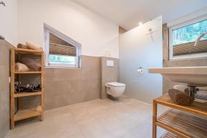 a bathroom with a toilet and a sink and a window at Alpenhaus Thurnher in Gaschurn +25 photos