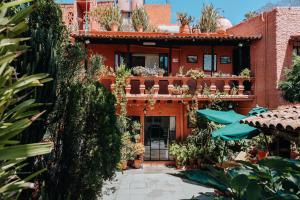 a red brick building with plants on it at Mansion del Bosque in San Miguel de Allende