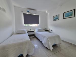 Voodi või voodid majutusasutuse Departamentos Temporarios Reggiardo toas