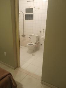 a bathroom with a toilet and a shower in it at ورده in Al Khobar