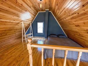 Habitación con cama en una cabaña de madera en BULUT BUNGALOW, en Akcaabat