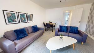 a living room with two couches and a table at Blakelock House Hartlepool Horizon Stays in Hartlepool