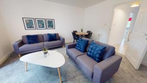 a living room with two couches and a table at Blakelock House Hartlepool Horizon Stays in Hartlepool