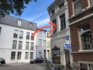 a red arrow is sticking out of a building at cosy small FLAT in Antwerp near Justice Palace in Antwerp