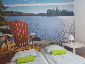 a rocking chair sitting next to a body of water at Apartamenty Welskie in Lidzbark