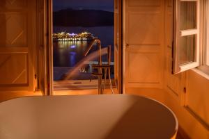 a kitchen with a large window with a view of the water at Elia Family Suites in Fira