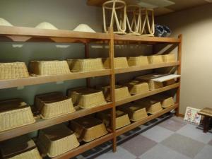 a shelf filled with baskets and bowls on it at Natsukashiya Fuwari in Nikko +20 photos