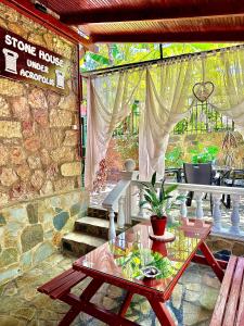 a stone house with a table and a stone house under renovation at Stone house under Acropolis in Athens