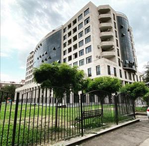 a large white building with a bench in front of it at DELUXE Modernly Renovated 2 Bedroom + 2 Bathroom Apt by REPUBLIC SQUARE in Yerevan