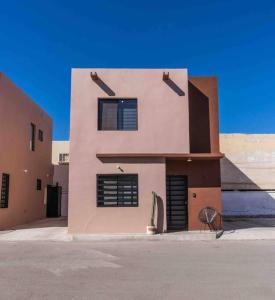 a building with black shuttered windows on a street at Condominiums Boutique Madera 3 in Ciudad Juárez