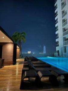 a swimming pool in a building at night at Night Blink Staycation and Rentals in Manila