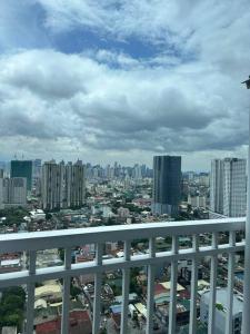 a view of a city from the balcony of a building at Night Blink Staycation and Rentals in Manila