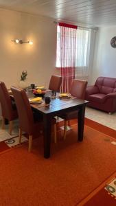 ein Wohnzimmer mit einem Tisch, Stühlen und einem Sofa in der Unterkunft Ferienwohnung-Schluecke in Bad Frankenhausen