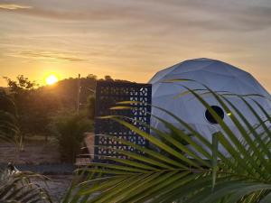 a dome tent with the sunset in the background at PRANA hOMe in San Carlos