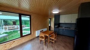 a kitchen with a table and chairs in a room at Shemoqmedi chalet 