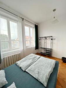 a bedroom with a bed in a room with windows at Nice View Rooms In Old Town in Kraków +11 photos