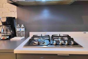 a stove top oven sitting on top of a kitchen counter at •Executive Suite• Quiet, Centrally & Comfortable in Ciudad Juárez